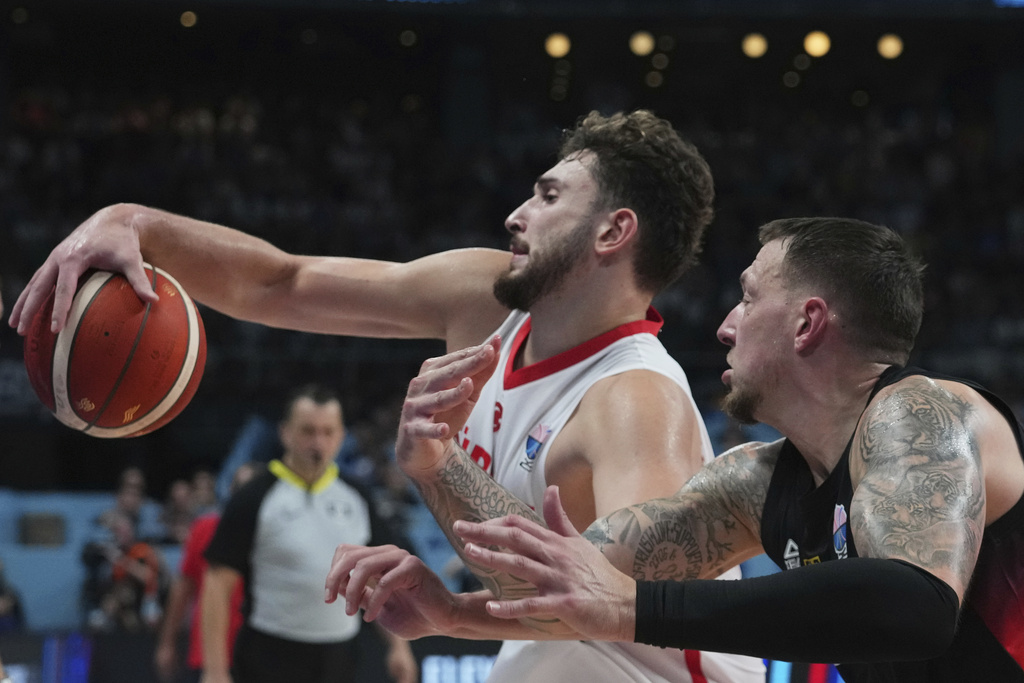 Turkey's Alperen Sengun drives to the basket as Germany's Daniel Theis tries to block him during the Eurobasket, European Basketball Championship final match between Turkey and Germany at the Riga Arena in Riga, Latvia, Sunday, Sept. 14, 2025. (AP Photo/Sergei Grits)