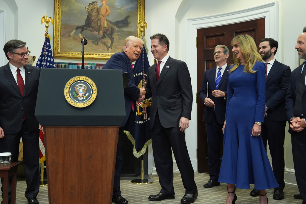 FILE - President Donald Trump shakes hands with Michael Dell as his wife Susan looks on, during an event on "Trump Accounts" for kids in the Roosevelt Room of the White House, Dec. 2, 2025, in Washington. (AP Photo/Evan Vucci, File)