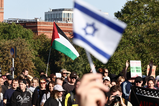 A flag of Israel is seen beside people protesting against Israel during a mass demonstration called "All Eyes on Gaza" in support of Palestinians in Berlin, Germany, Saturday, Sept. 27, 2025. (AP Photo/Christoph Soeder) A flag of Israel is seen beside people protesting against Israel during a mass demonstration called "All Eyes on Gaza" in support of Palestinians in Berlin, Germany, Saturday, Sept. 27, 2025. (AP Photo/Christoph Soeder)