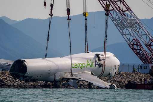The wreckage of a cargo aircraft that skidded off a runway at the Hong Kong International Airport is prepared for removal on Sunday, Oct. 26, 2025. (AP Photo/Vernon Yuen) The wreckage of a cargo aircraft that skidded off a runway at the Hong Kong International Airport is prepared for removal on Sunday, Oct. 26, 2025. (AP Photo/Vernon Yuen)