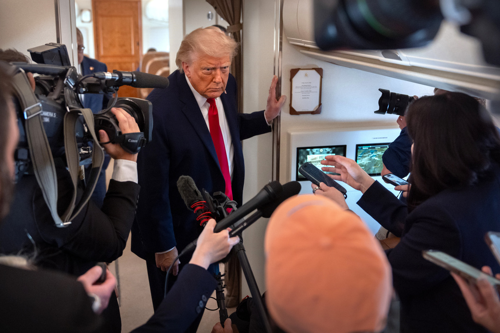 President Donald Trump speaks to reporters aboard Air Force One en route from Joint Base Andrews, Md., to Eau Claire, Wis., Friday, June 5, 2026. (AP Photo/Mark Schiefelbein)