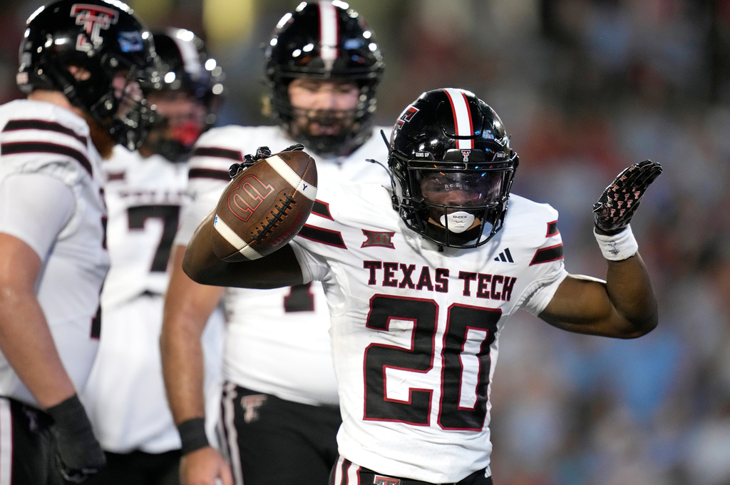 Texas Tech running back J'Koby Williams (20) celebrates his touchdown against Houston during the first half of an NCAA college football game, Saturday, Oct. 4, 2025, in Houston. (AP Photo/Karen Warren)