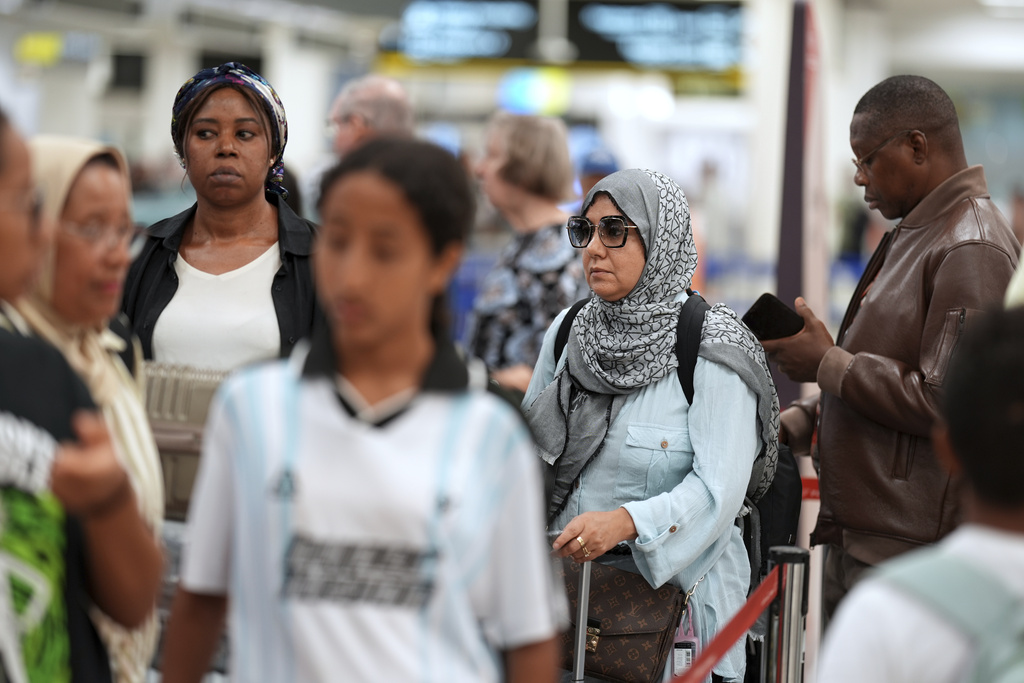 Travelers check in for international flights in the Miami International Airport at the start of the Labor Day weekend, Friday, Aug. 29, 2025, in Miami. (AP Photo/Rebecca Blackwell)