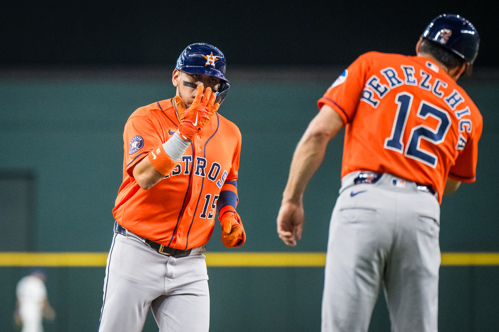 Houston Astros' Isaac Paredes celebrates a home run with Houston Astros' third base coach Tony Perezchica during the first inning of a baseball game against the Texas Rangers, Thursday, May 28, 2026, Arlington, Texas. (AP Photo/Jessica Tobias)