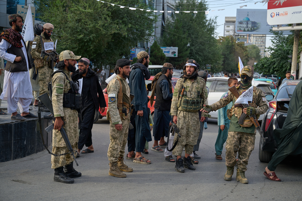 Armed Taliban police stand along a street ahead of celebrations marking the fifth anniversary of the U.S. withdrawal and the start of Taliban rule in Kabul, Afghanistan, Friday, Aug. 14, 2026. (AP Photo/Nava Jamshidi)
