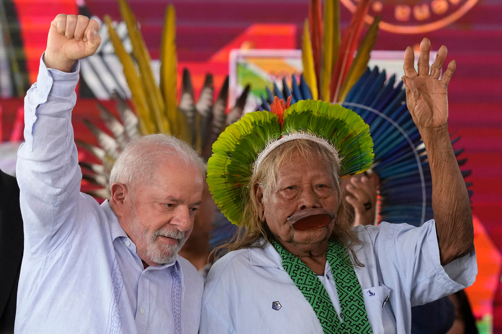 FILE - Brazilian President Luiz Inacio Lula da Silva, left, and Cacique Caiapo, Raoni Metuktire, greet the audience as they arrive for the closing of the annual Terra Livre, or Free Land Indigenous Encampment in Brasilia, Brazil, April 28, 2023. (AP Photo/Eraldo Peres, File)