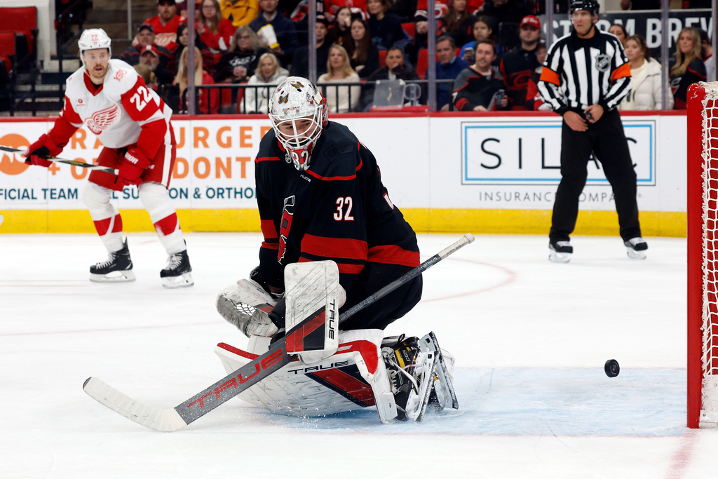 Carolina Hurricanes goaltender Brandon Bussi (32) looks back as the puck comes back out of the net after a goal by Detroit Red Wings' Michael Rasmussen during the first period of an NHL hockey game in Raleigh, N.C., Saturday, Dec. 27, 2025. (AP Photo/Karl DeBlaker)