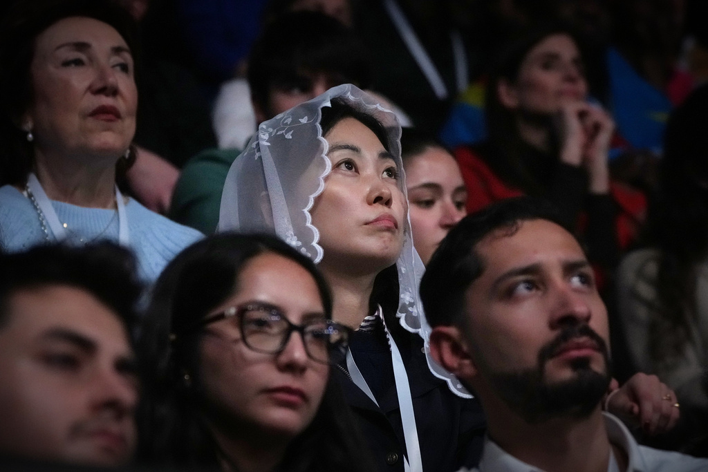 People attend a Mass celebrated by Pope Leo XIV at the Volkswagen Arena, in Istanbul, Turkey, Saturday, Nov. 29, 2025. (AP Photo/Dilara Acikgoz)