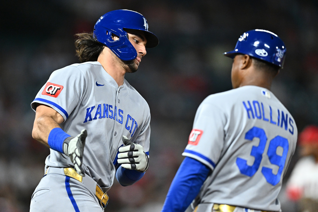 Kansas City Royals' Jac Caglianone, left, is greeted by first base coach Damon Hollins (39) after hitting a two-run home run during the fifth inning of a baseball game against the Los Angeles Angels, Friday, Aug. 14, 2026, in Anaheim, Calif. (AP Photo/William Liang)