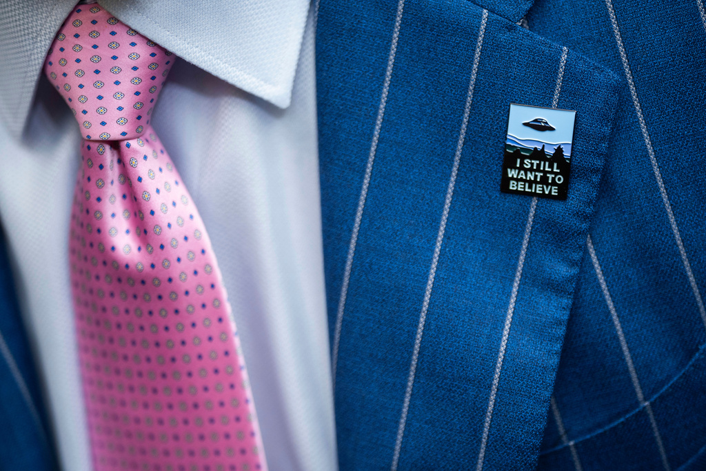 FILE - An audience member wears a UFO pin during a House Oversight and Accountability subcommittee hearing on UFOs, July 26, 2023, on Capitol Hill in Washington. (AP Photo/Nathan Howard, File)