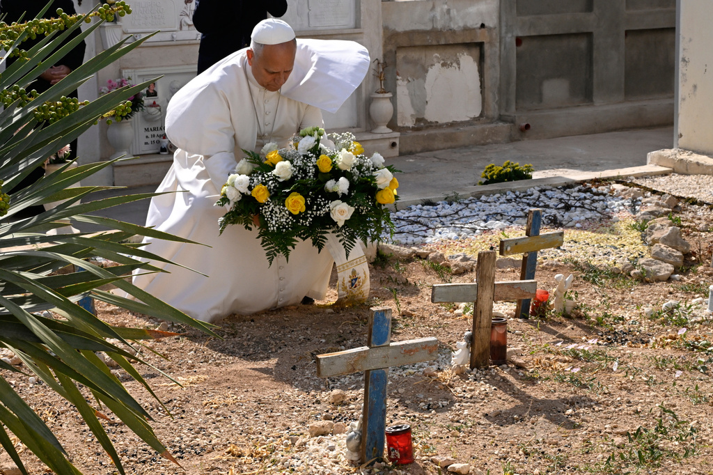 Pope Leo XIV pays tribute at the cemetery and on little Joussef's grave, in Lampedusa, Sicily, southern Italy, Saturday, July 4, 2026, during a one-day pastoral visit to an island that has become a symbol of the risks faced by migrants trying to reach Europe by sea.(Pool Photo/Ciro Fusco, Via AP)