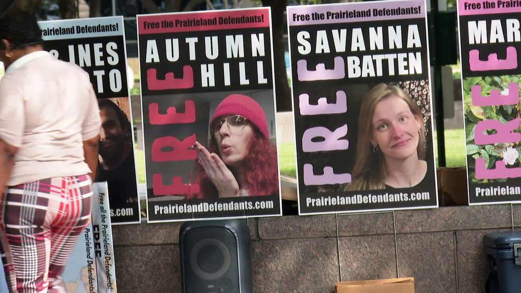 Supporters of protesters convicted over a shooting outside a Texas immigration detention center display signs in support of the defendants outside a federal courthouse in Fort Worth, Texas on Tuesday, June 23, 2026. (AP Photo/Kendria LaFleur)