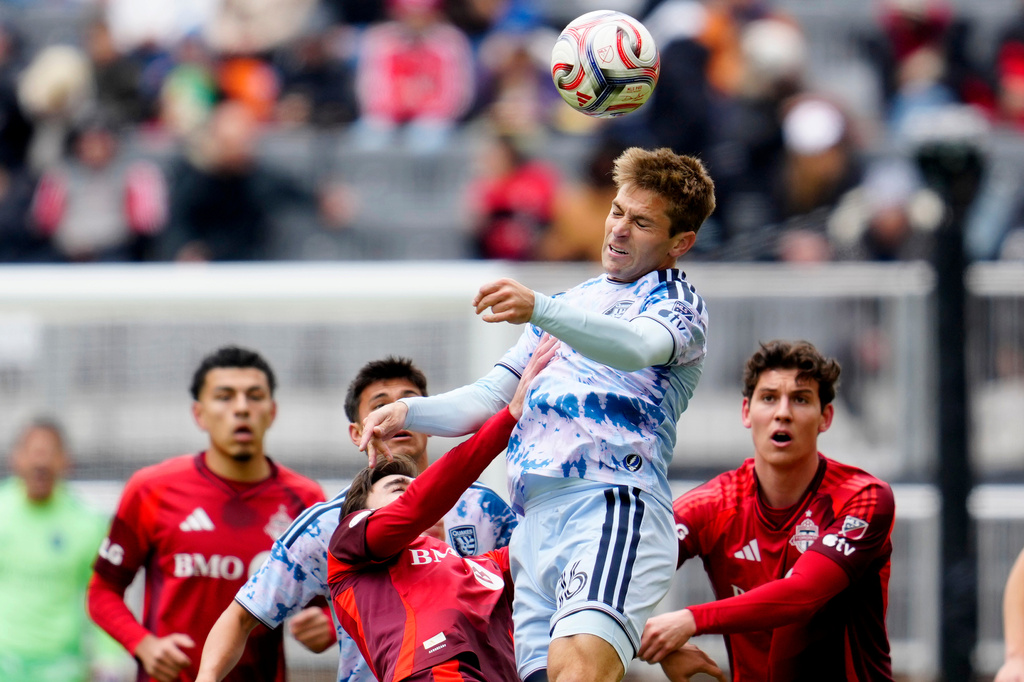 San Jose Earthquakes midfielder Jack Skahan (16) heads the ball as Toronto FC players look on during the first half of an MLS soccer game in Toronto, Saturday, May 2, 2026. (Frank Gunn/The Canadian Press via AP)