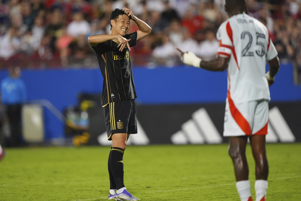 Los Angeles FC forward Heung Min Son, left, looks to FC Dallas defender Sebastien Ibeagha (25) during the second half of an MLS soccer match in Frisco, Texas, Saturday, Aug. 23, 2025. (AP Photo/LM Otero)