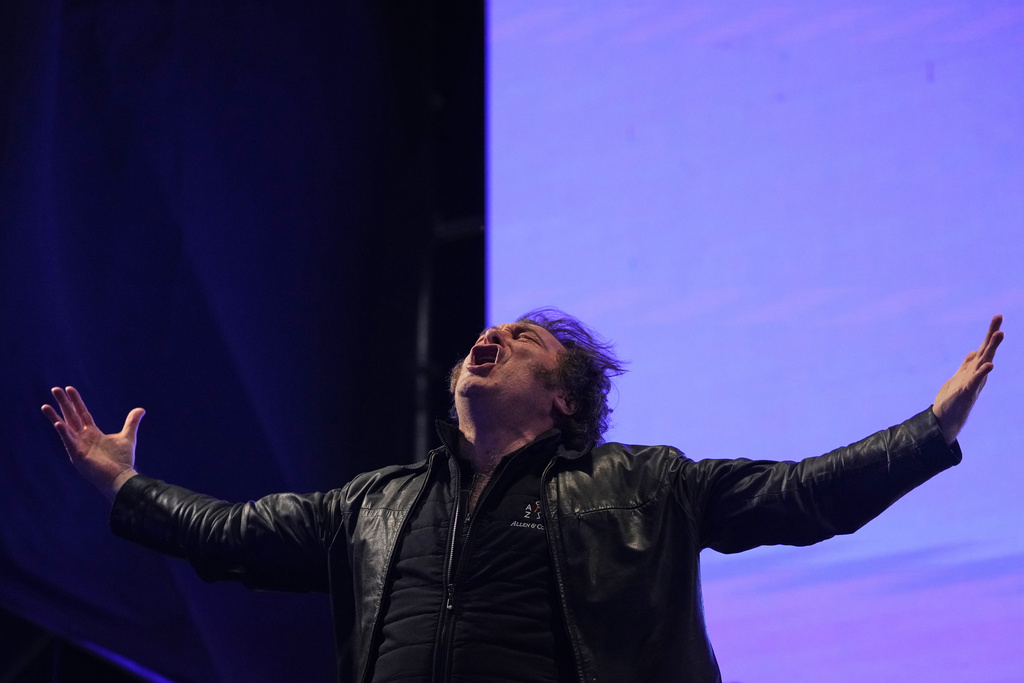 President Javier Milei sings during at a rally for his party's candidates ahead of the upcoming midterm elections, in Rosario, Argentina, Thursday, Oct. 23, 2025. (AP Photo/Rodrigo Abd)