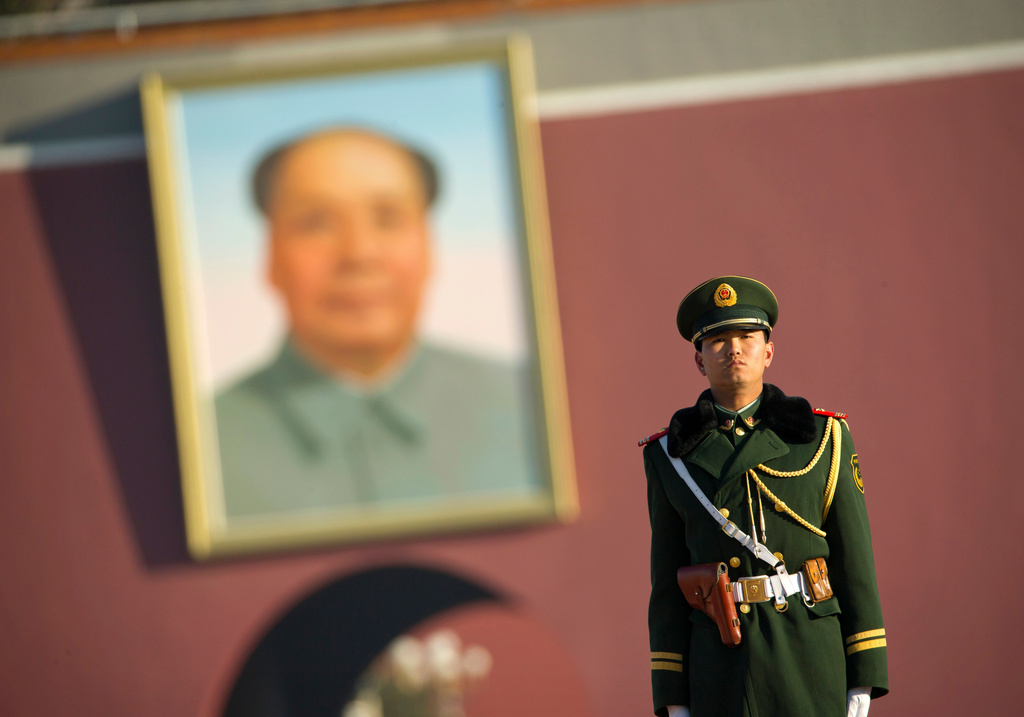 FILE - A Chinese soldier stands guard on Tiananmen Square near the large portrait of late Chinese leader Mao Zedong on the Gate of Heavenly Peace in Beijing, Tuesday, March 10, 2015. (AP Photo/Mark Schiefelbein, file)