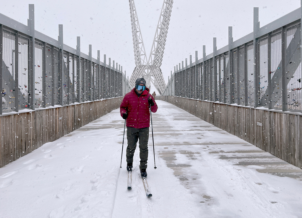 Jacob Coleman skis across SkyDance Bridge over Interstate 40 during a snowstorm in Oklahoma City on Saturday, Jan. 24, 2026. (AP Photo/Thomas Peipert)