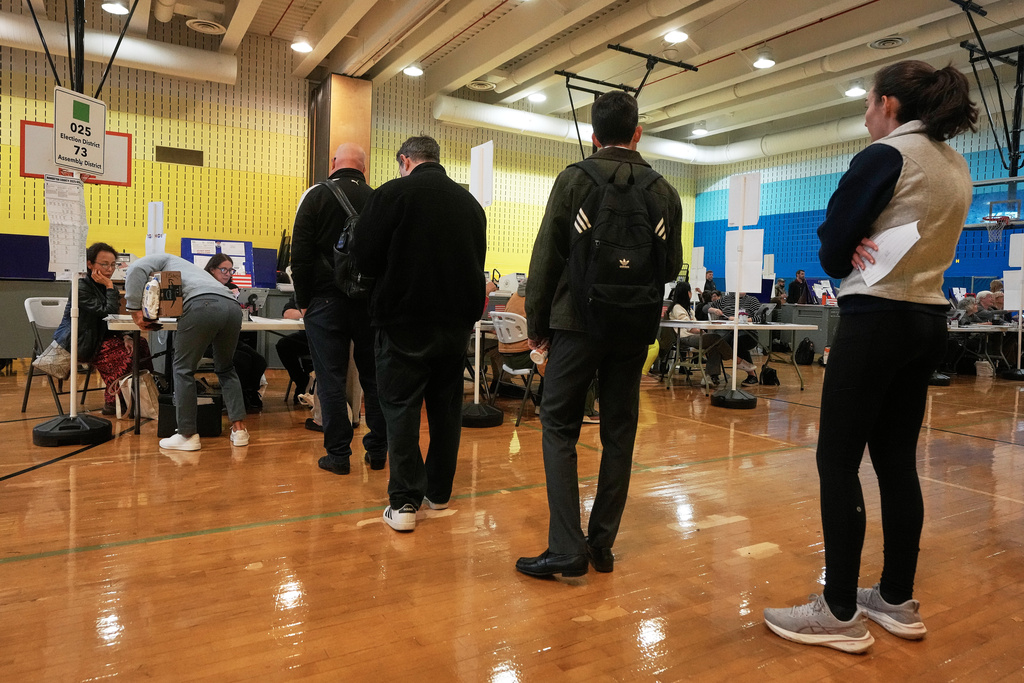 Voters sign-in at a polling site, in New York, Tuesday, Nov. 4, 2025. (AP Photo/Richard Drew)