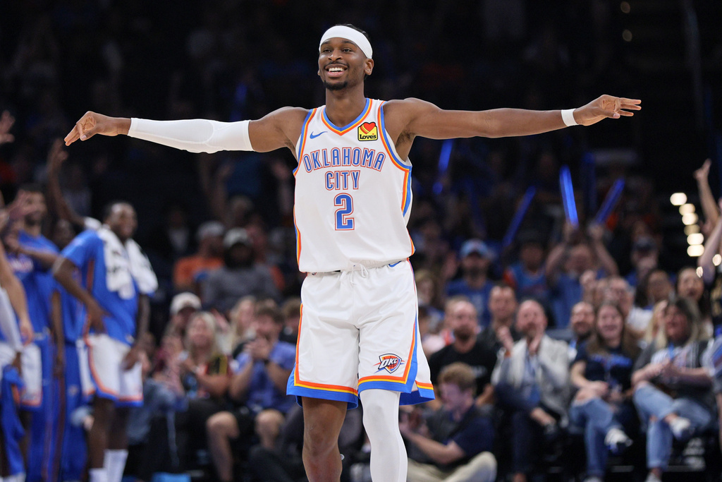 Oklahoma City Thunder guard Shai Gilgeous-Alexander reacts after a teammate scored during the first half of a preseason NBA basketball game against the Charlotte Hornets, Thursday, Oct. 9, 2025, in Oklahoma City. (AP Photo/Nate Billings)