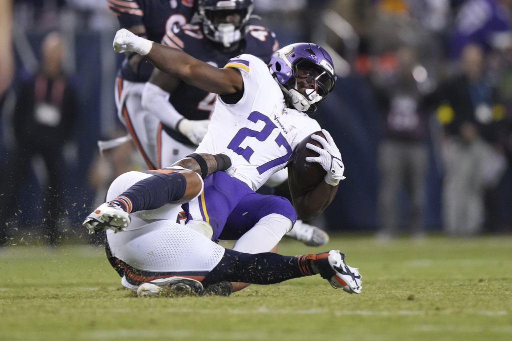 Minnesota Vikings running back Jordan Mason (27) is stopped by Chicago Bears linebacker Noah Sewell during the second half of an NFL football game Monday, Sept. 8, 2025, in Chicago. (AP Photo/Nam Y. Huh)
