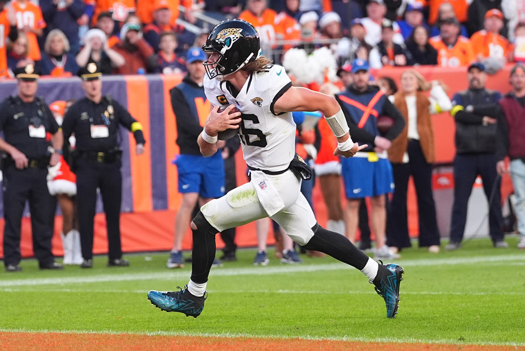 Jacksonville Jaguars quarterback Trevor Lawrence runs for a touchdown against the Denver Broncos during the second half of an NFL football game in Denver, Sunday, Dec. 21, 2025. (AP Photo/David Zalubowski)