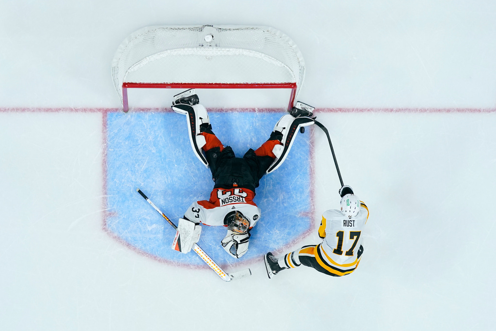 Philadelphia Flyers' Samuel Ersson, left, blocks a shot by Pittsburgh Penguins' Bryan Rust during a shootout in an NHL hockey game, Tuesday, Oct. 28, 2025, in Philadelphia. (AP Photo/Matt Slocum)