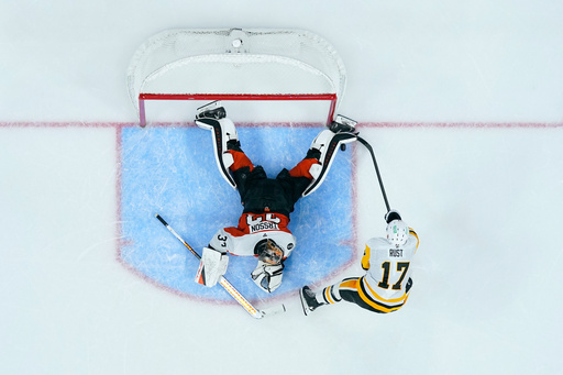 Philadelphia Flyers' Samuel Ersson, left, blocks a shot by Pittsburgh Penguins' Bryan Rust during a shootout in an NHL hockey game, Tuesday, Oct. 28, 2025, in Philadelphia. (AP Photo/Matt Slocum) Philadelphia Flyers' Samuel Ersson, left, blocks a shot by Pittsburgh Penguins' Bryan Rust during a shootout in an NHL hockey game, Tuesday, Oct. 28, 2025, in Philadelphia. (AP Photo/Matt Slocum)