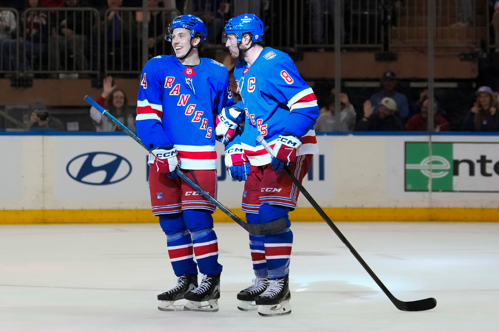 New York Rangers right wing Gabe Perreault (94) celebrates with center J.T. Miller (8) after scoring his third goal of the game during the period of an NHL hockey game against Detroit Red Wings, Saturday, April 4, 2026, in New York. (AP Photo/Yuki Iwamura)