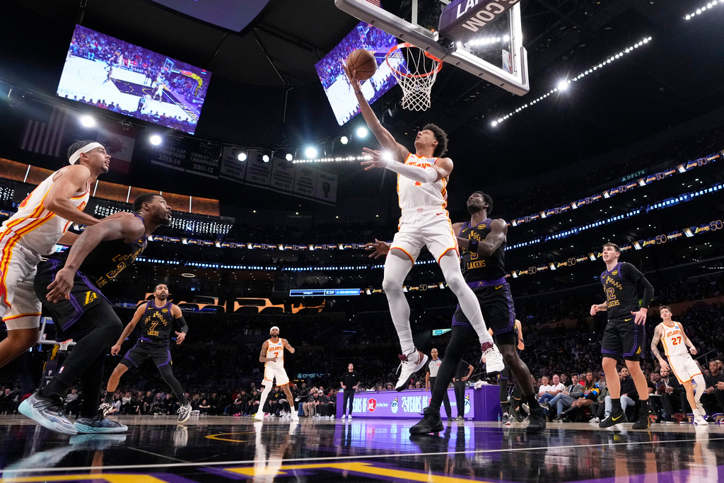 Atlanta Hawks forward Jalen Johnson (1) shoots as Los Angeles Lakers center Deandre Ayton defends during the first half of an NBA basketball game Tuesday, Jan. 13, 2026, in Los Angeles. (AP Photo/Mark J. Terrill)