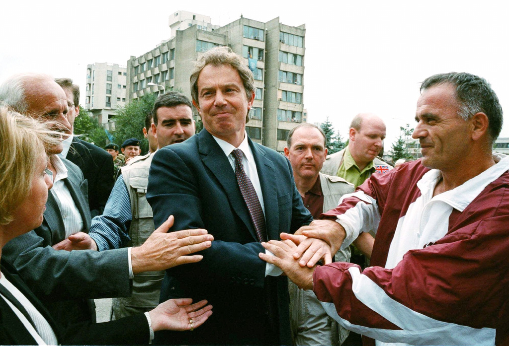 FILE - British Prime Minister Tony Blair greets ethnic Albanians in central Pristina, Yugoslavia during a one-day visit, Saturday July 31, 1999. (AP Photo/David Brauchli, File)