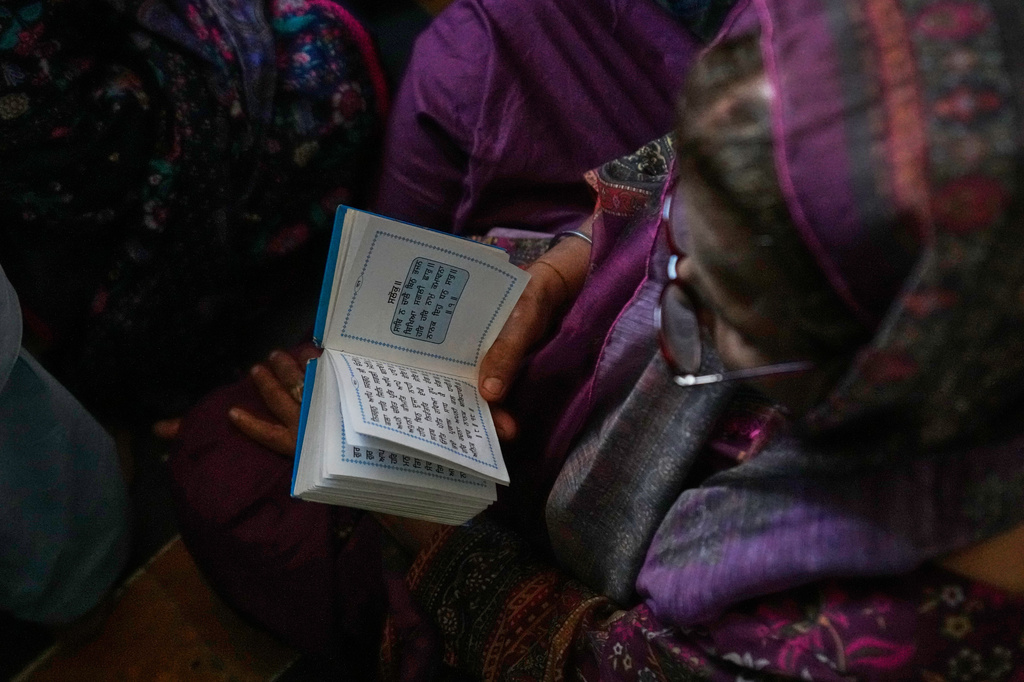 A Sikh pilgrim reads her holy book in a ceremony to celebrate Vaisakhi festival, which also marks the New Year in Sikh tradition, at the shrine of Gurdwara Panja Sahib in Hassan Abdal, Pakistan, Tuesday, April 14, 2026. (AP Photo/Anjum Naveed)