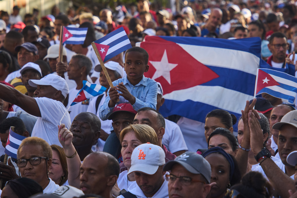 People attend a celebration marking the 65th anniversary of the proclamation declaring the Cuban Revolution socialist, in Havana, Cuba, Thursday, April 16, 2026. (AP Photo/Ramon Espinosa)