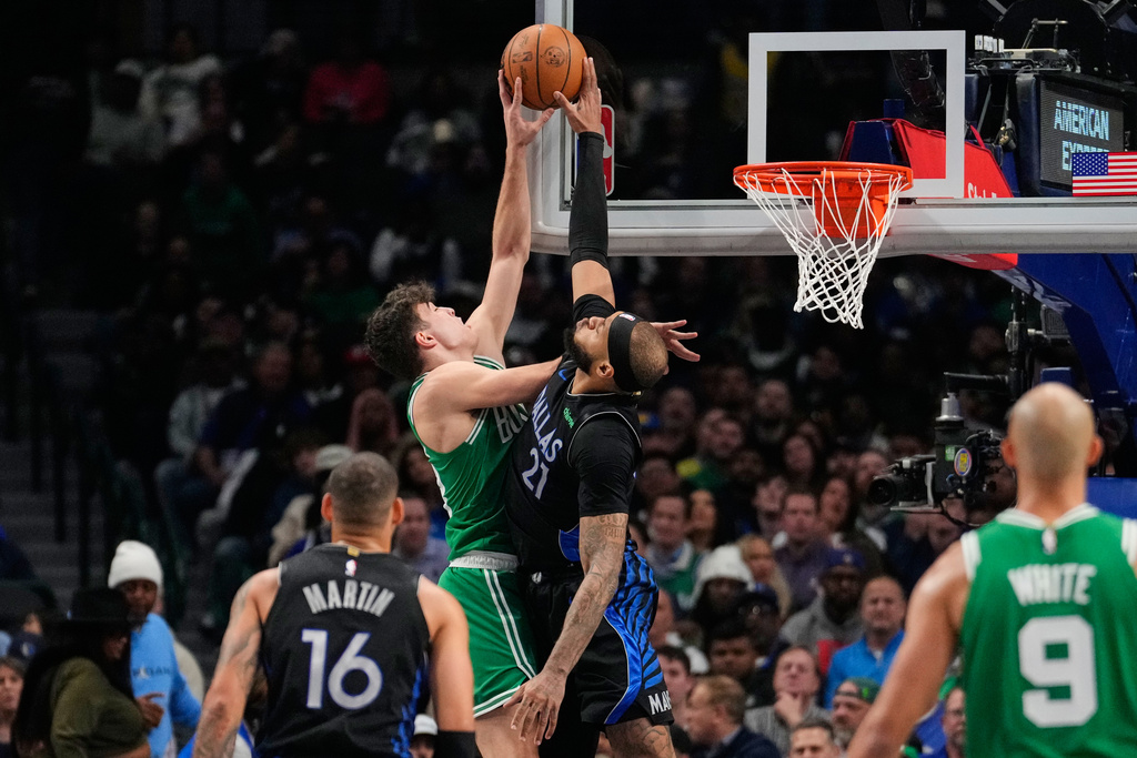 Boston Celtics guard Hugo Gonzalez, left, has his shot blocked b y Dallas Mavericks' Daniel Gafford (21) in the first half of an NBA basketball game Tuesday, Feb. 3, 2026, in Dallas. (AP Photo/Tony Gutierrez)
