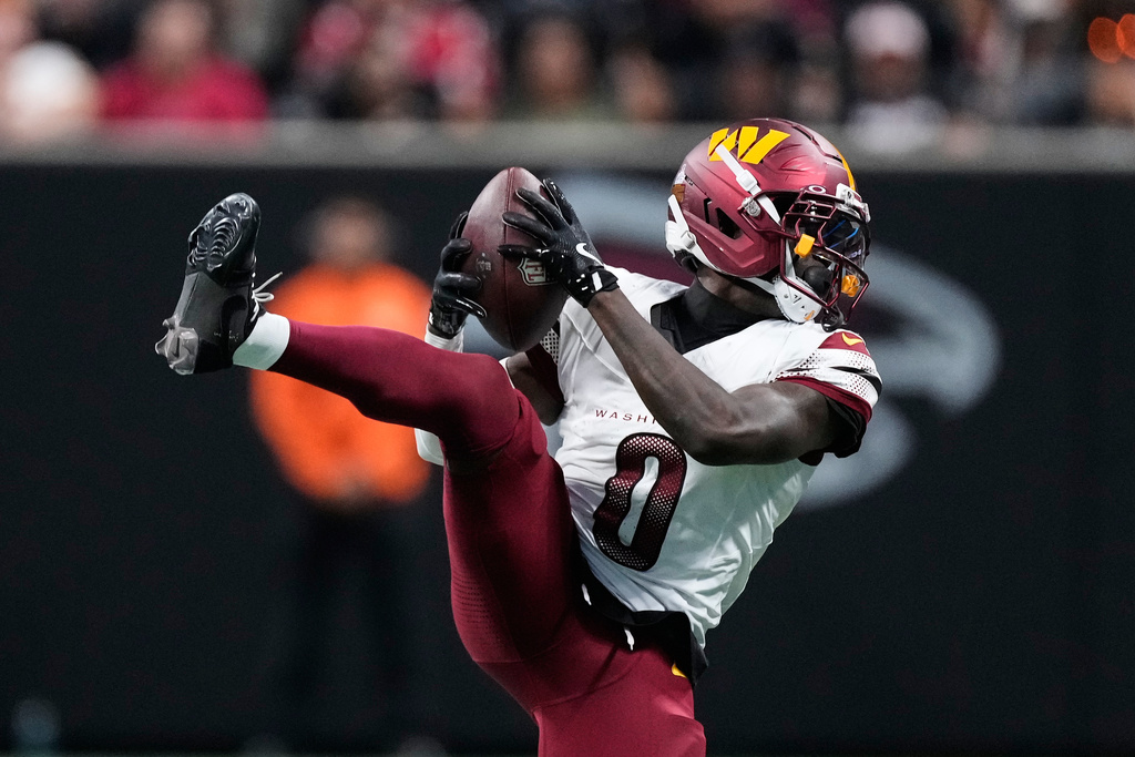 Washington Commanders cornerback Mike Sainristil intercepts a pass by Atlanta Falcons quarterback Michael Penix Jr. that was intended for Falcons wide receiver Drake London during the second half of an NFL football game, Sunday, Sept. 28, 2025, in Atlanta. (AP Photo/Brynn Anderson)