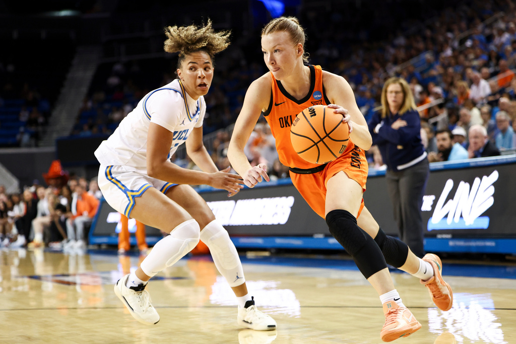 Oklahoma State guard Haleigh Timmer, right, drives against UCLA guard Kiki Rice, left, during the first half in the second round of the NCAA college basketball tournament, Monday, March 23, 2026, in Los Angeles. (AP Photo/Jessie Alcheh)
