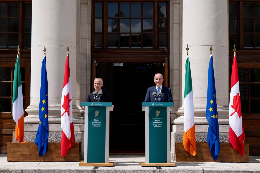 Prime Minister Mark Carney, left, gives remarks alongside Micheal Martin, Ireland's head of government, at the Government Buildings in Dublin, on Saturday, June 13, 2026. (Christopher Katsarov /The Canadian Press via AP)
