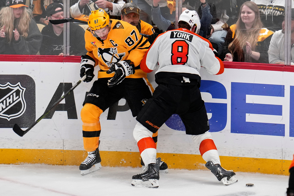 Pittsburgh Penguins' Sidney Crosby (87) is checked off the puck by Philadelphia Flyers' Cam York (8) during the third period of Game 5 in the first round of an NHL hockey Stanley Cup playoff series in Pittsburgh, Monday, April 27, 2026. (AP Photo/Gene J. Puskar)