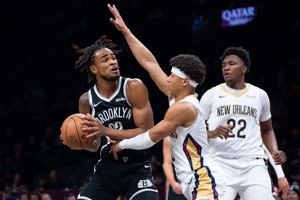 Brooklyn Nets center Nic Claxton (33), guarded by New Orleans Pelicans guard Jeremiah Fears (0) looks for an opening during the first half of an NBA basketball game, Saturday, Dec. 6, 2025, in New York. (AP Photo/Angelina Katsanis)