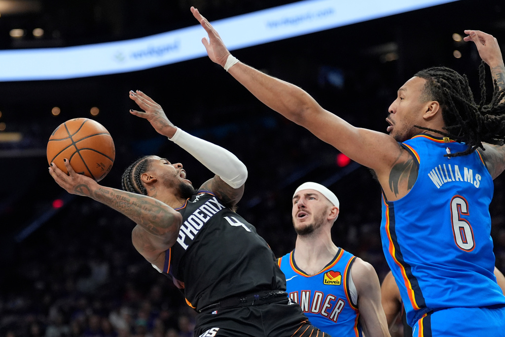 Phoenix Suns guard Jalen Green (4) tries to get off a shot against Oklahoma City Thunder guard Alex Caruso, center, and Thunder forward Jaylin Williams (6) during the first half of Game 3 of a first-round NBA playoffs basketball series, Saturday, April 25, 2026, in Phoenix. (AP Photo/Ross D. Franklin)