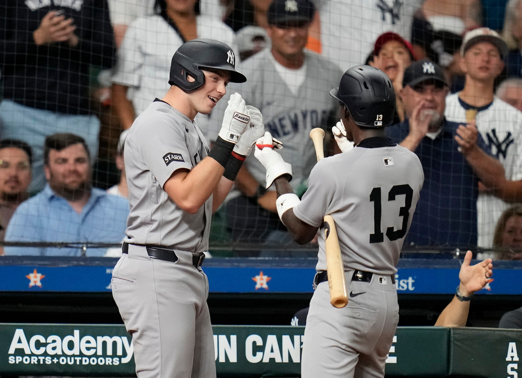 New York Yankees' Ben Rice, left, celebrates after his home run with Jazz Chisholm Jr. (13) during the seventh inning of a baseball game against the Houston Astros, Friday, April 24, 2026, in Houston. (AP Photo/Karen Warren)