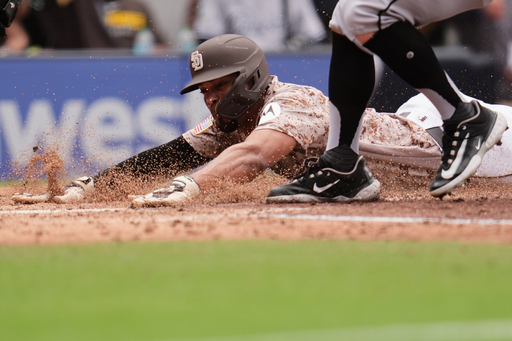 San Diego Padres' Xander Bogaerts slides in to score from third off a passed ball during the fourth inning of a baseball game against the Chicago White Sox Sunday, May 3, 2026, in San Diego. (AP Photo/Gregory Bull)