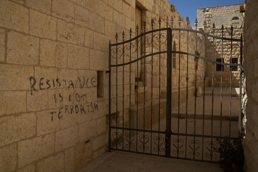 A message of resistance is written in English on a wall of an alley in the Old City of Taybeh, in the West Bank, Sept. 28, 2025. (AP Photo/Leo Correa) A message of resistance is written in English on a wall of an alley in the Old City of Taybeh, in the West Bank, Sept. 28, 2025. (AP Photo/Leo Correa)