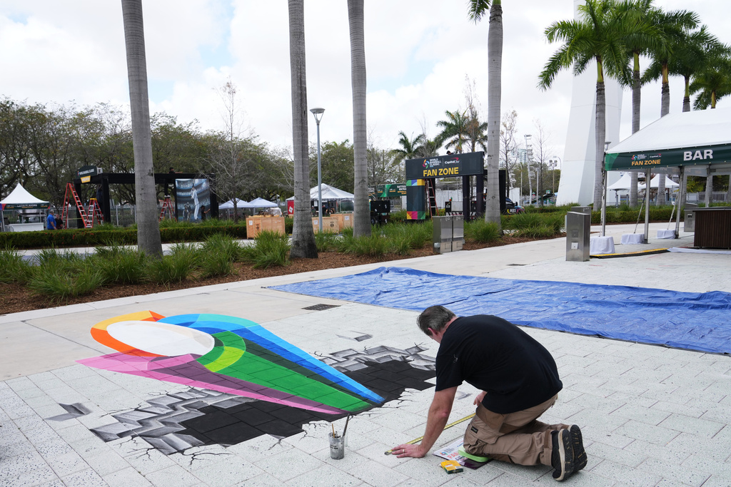Artist Mike Macaulay paints a World Baseball Classic logo outside of loanDepot Park in advance of the World Baseball Classic, Thursday, March 5, 2026, in Miami. (AP Photo/Lynne Sladky)