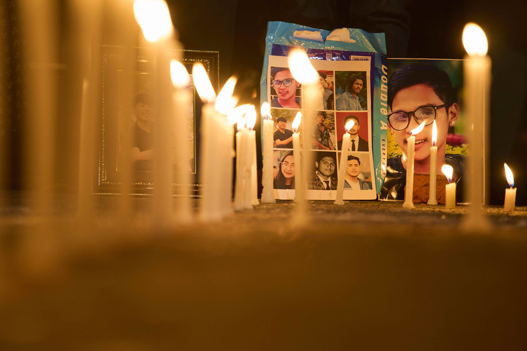 Photos of people who were killed during the Sept. 8 protest are placed outside the morgue of Teaching Hospital in Kathmandu, Nepal, during a candlelight vigil, Thursday, Sept. 11, 2025. (AP Photo/Niranjan Shrestha)