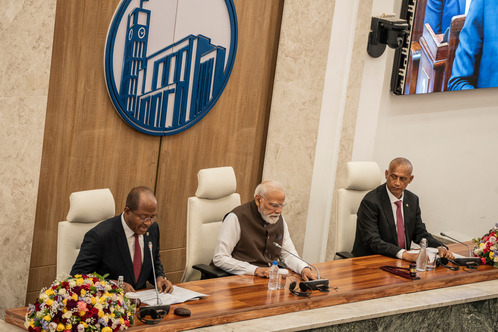 Indian Prime Minister Narendra Modi, center, sits between Ethiopia's House of People's Representatives Speaker Tagesse Chafo, left, and House of Federation Speaker Agegnehu Teshager during a visit at the parliament in Addis Ababa, Ethiopia, Wednesday, Dec. 17, 2025. (AP Photo/ Amanuel Sileshi)