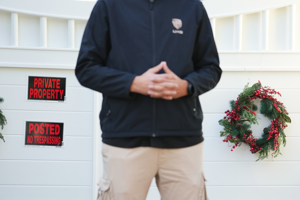 A security guard stands outside Rob Reiner's residence Monday, Dec. 15, 2025, in the Brentwood section of Los Angeles. (AP Photo/Chris Pizzello)