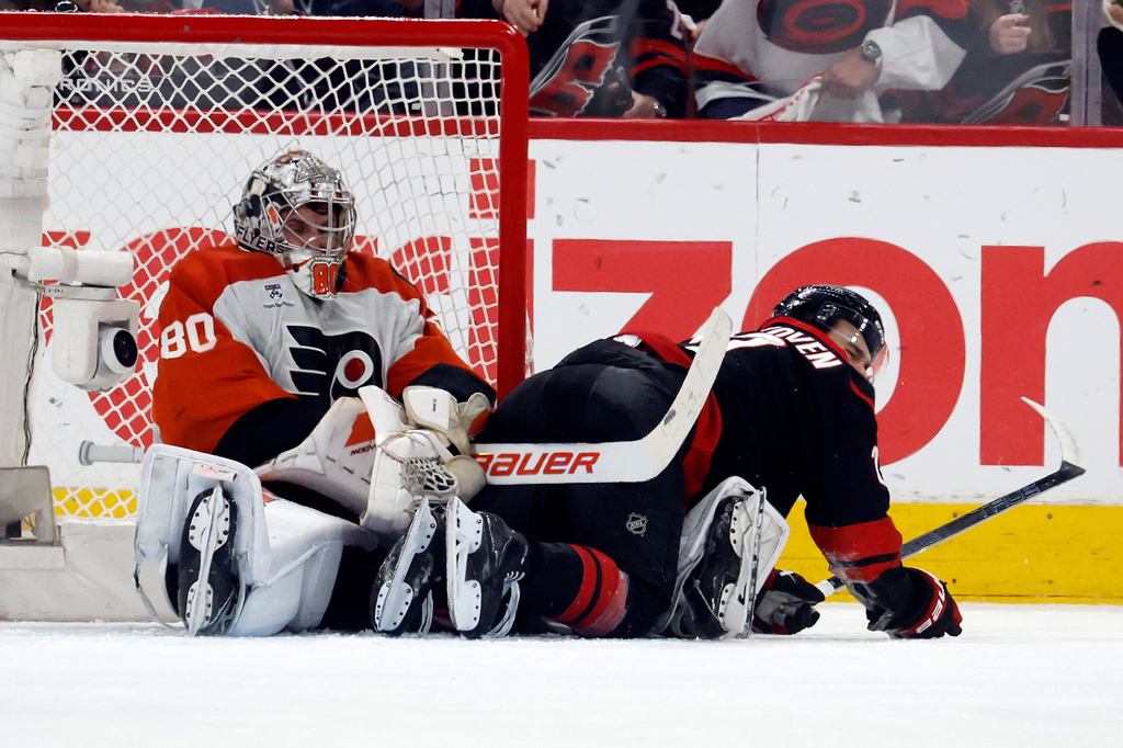 Carolina Hurricanes' Logan Stankoven, right, collides with Philadelphia Flyers goaltender Dan Vladar (80) during the third period of Game 2 of an NHL hockey Stanley Cup second-round playoff series in Raleigh, N.C., Monday, May 4, 2026. (AP Photo/Karl DeBlaker)