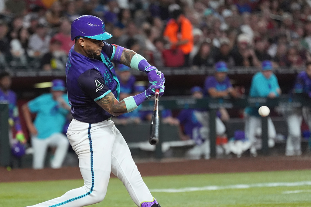 Arizona Diamondbacks' Ketel Marte connects for a two-run double against the Texas Rangers during the fifth inning of a baseball game, Friday, Sept. 11, 2026, in Phoenix. (AP Photo/Ross D. Franklin)