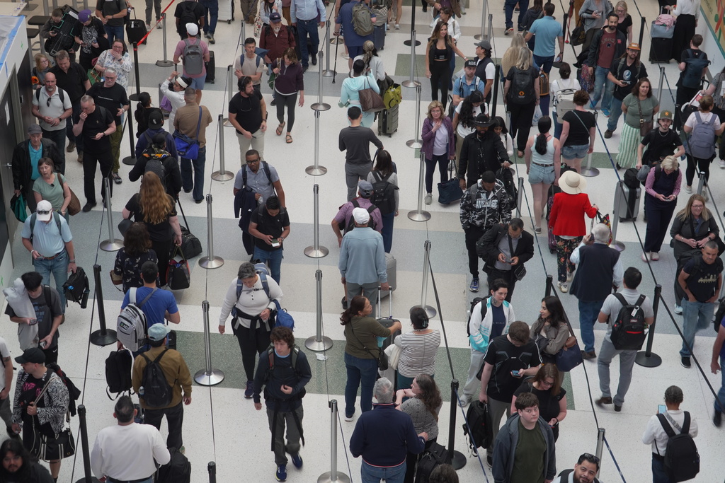 Travelers line up at a TSA checkpoint at George Bush Intercontinental Airport in Houston, Tuesday, March 24, 2026. (AP Photo/Lekan Oyekanmi)