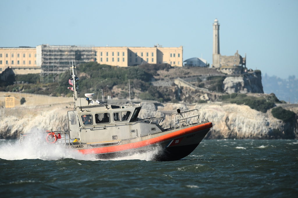 A U.S. Coast Guard crew goes past Alcatraz Island near the site of a pontoon boat accident on Tuesday, July 14, 2026, in San Francisco. (AP Photo/Noah Berger)